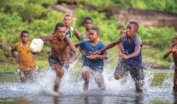 Young fijian boys playing rugby in the river, Navala Village, Nadi Young fijian boys playing rugby in the river, Navala Village, Nadi