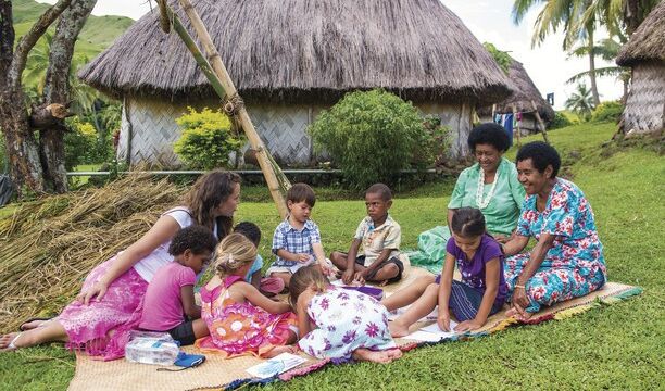 Children colouring with fijian ladies, Navala Village, Nadi region Children colouring with fijian ladies, Navala Village, Nadi region
