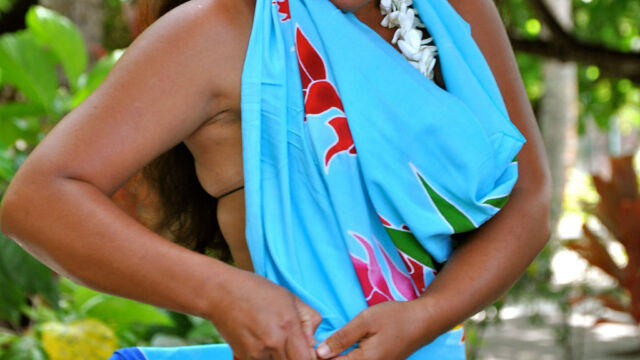 Woman tying the Tahitian Pareo - sarong at Le Taha'a Resort, French Polynesia. Woman tying the Tahitian Pareo - sarong at Le Taha'a Resort, French Polynesia.