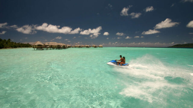 Jet skiing in the lagoon at Le Taha'a Resort and Spa, French Polynesia