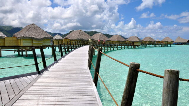 Overwater bungalows in the lagoon at Le Taha'a Resort and Spa, French Polynesia.
